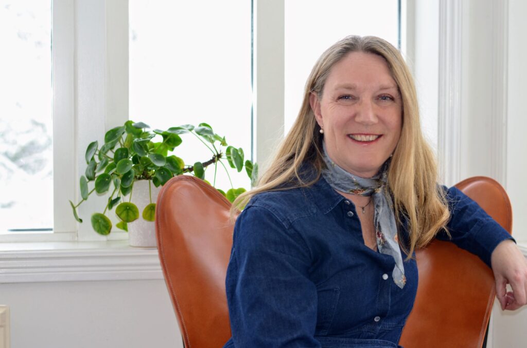 Karin Anding sitting in front of a window
